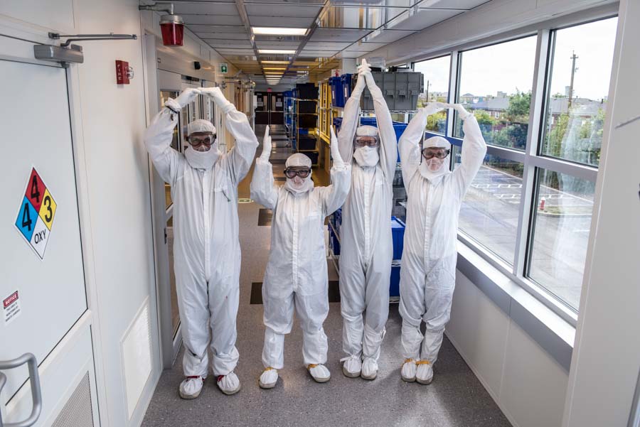 Researchers spell out "Ohio" similar to flag semaphore system in the Nanotech West Lab cleanroom.
