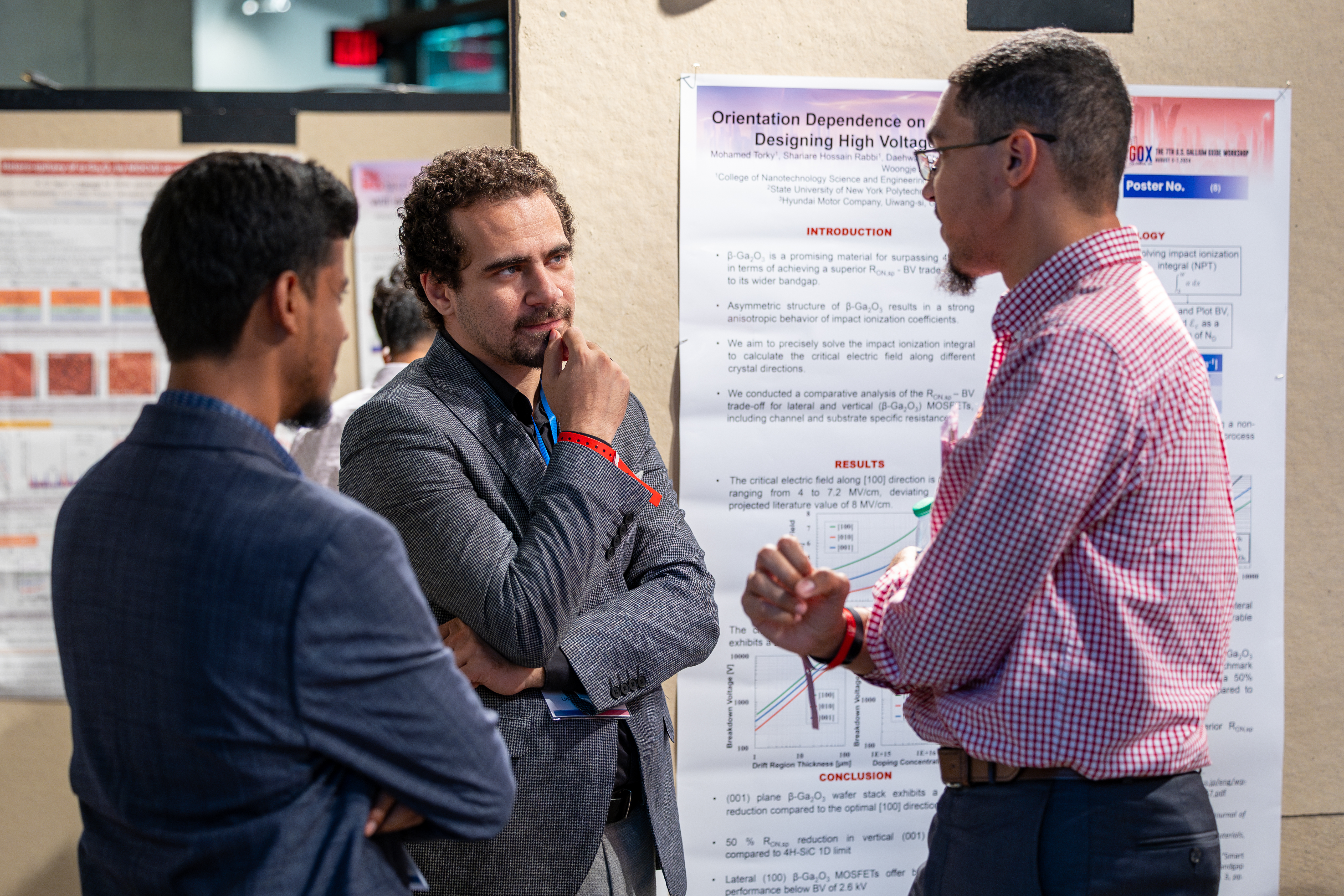 Students discuss research during the poster session at GOX 2024.