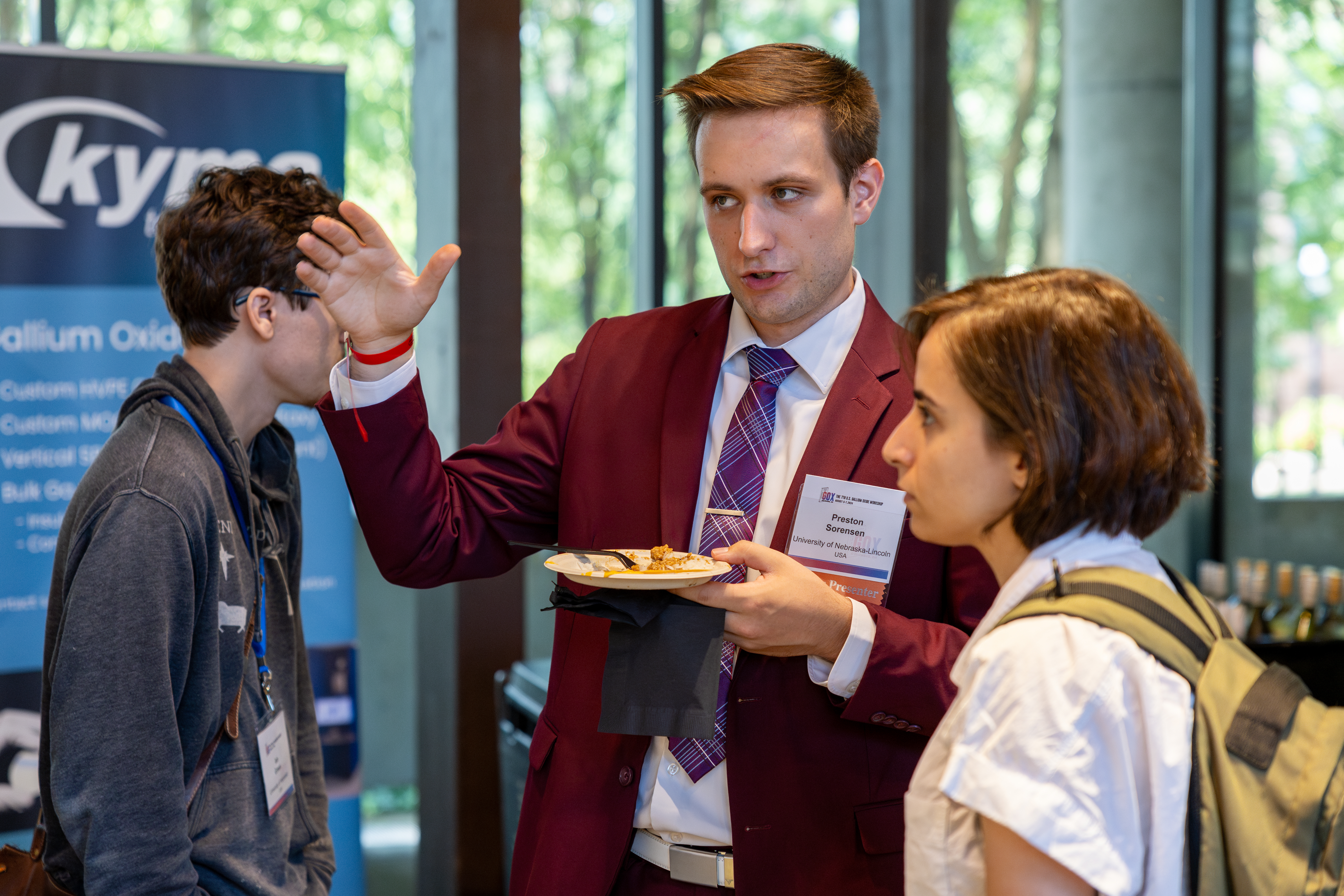 Students discuss research during the poster session at GOX 2024.