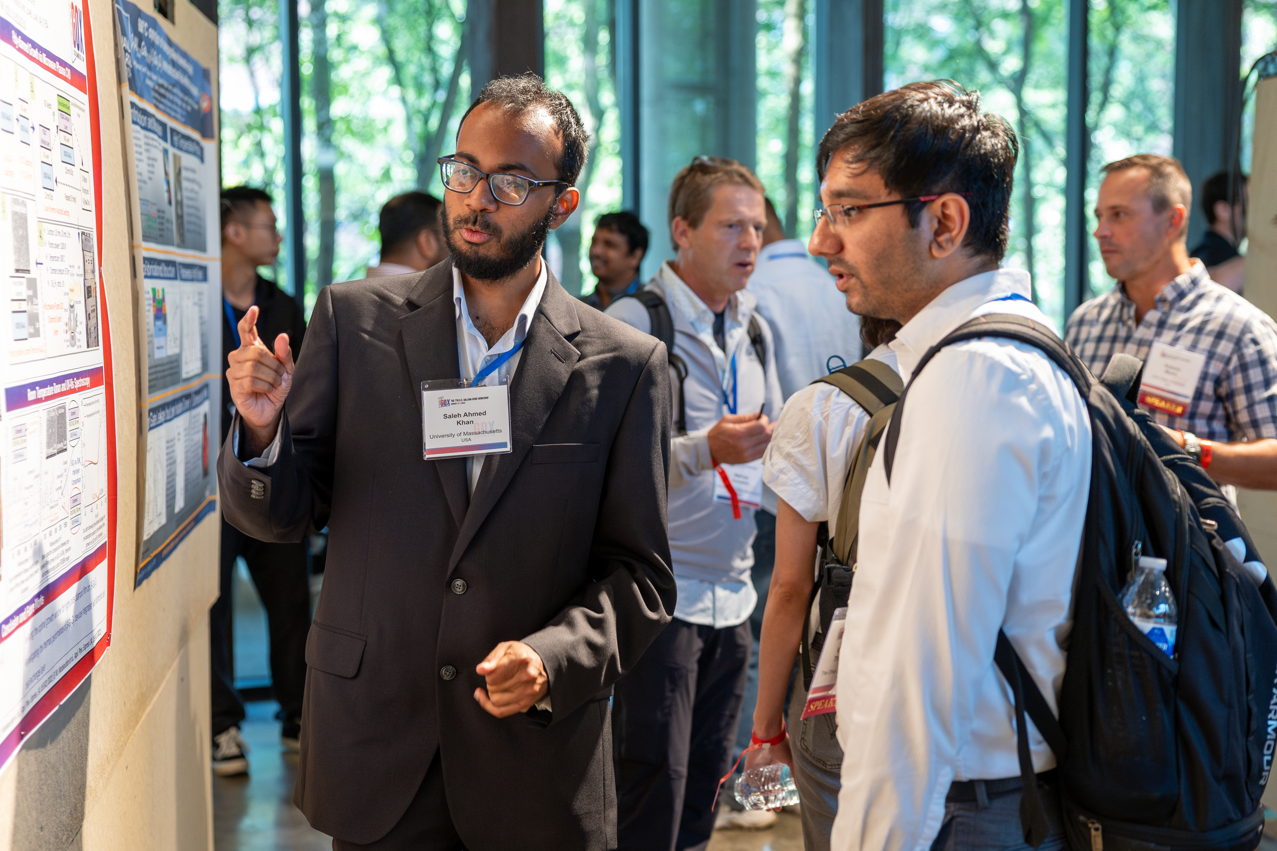 Students discuss research during the poster session at GOX 2024.