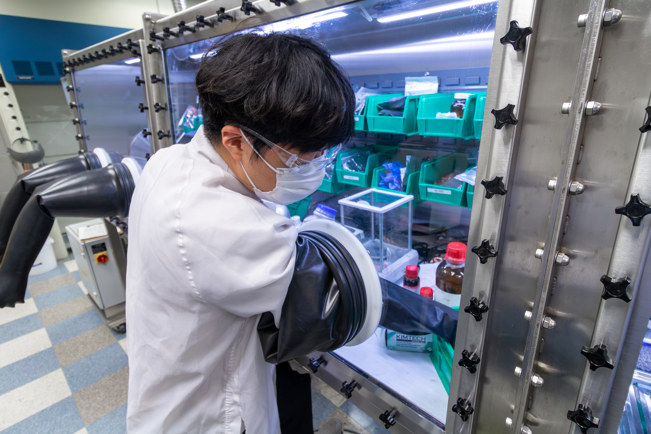 Ohio State student researcher works at a glovebox at the Energy Innovation Lab at Nanotech West Lab.