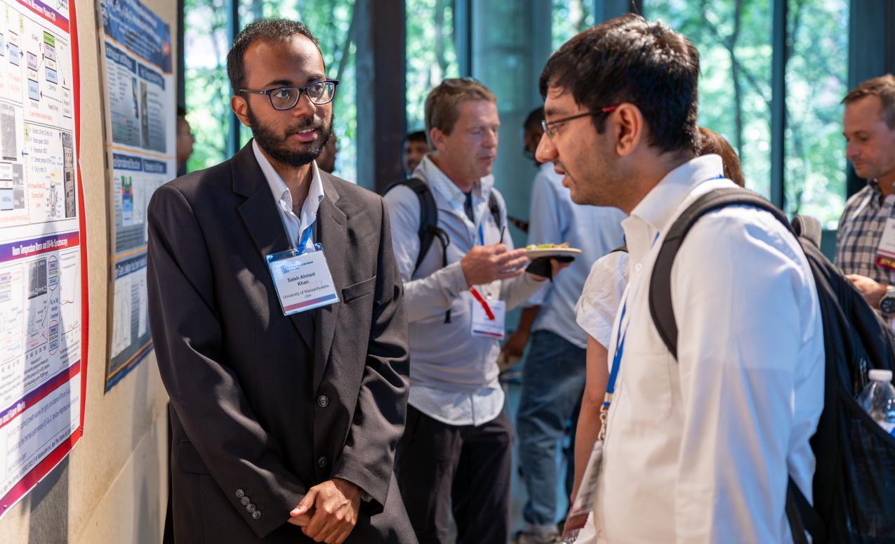 Students discuss their research at the GOX 2024 poster session.