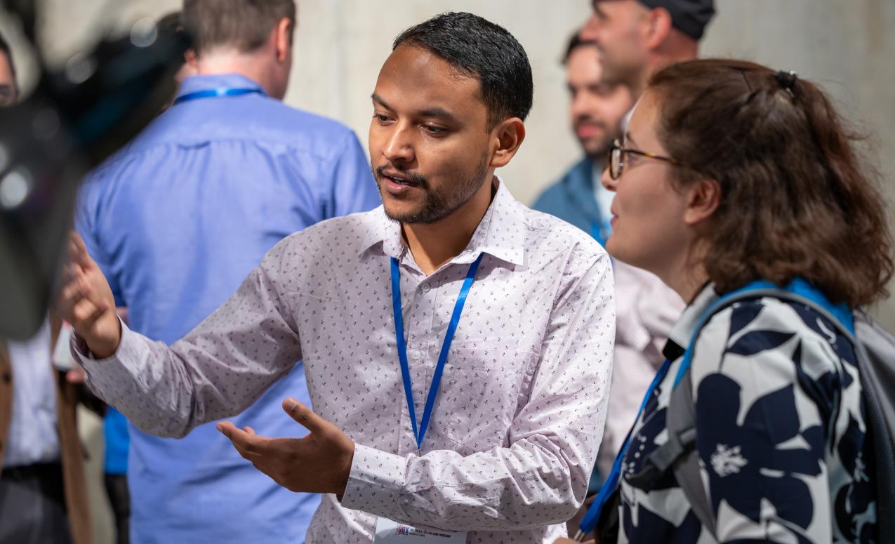 Students discuss research at GOX 2024 poster session.