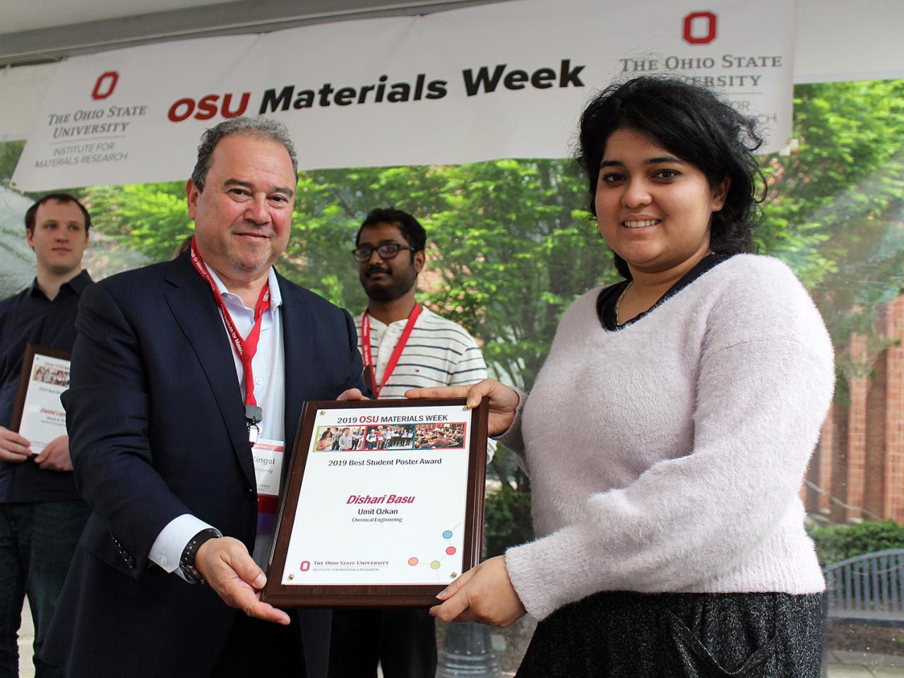 Woman being presented with award