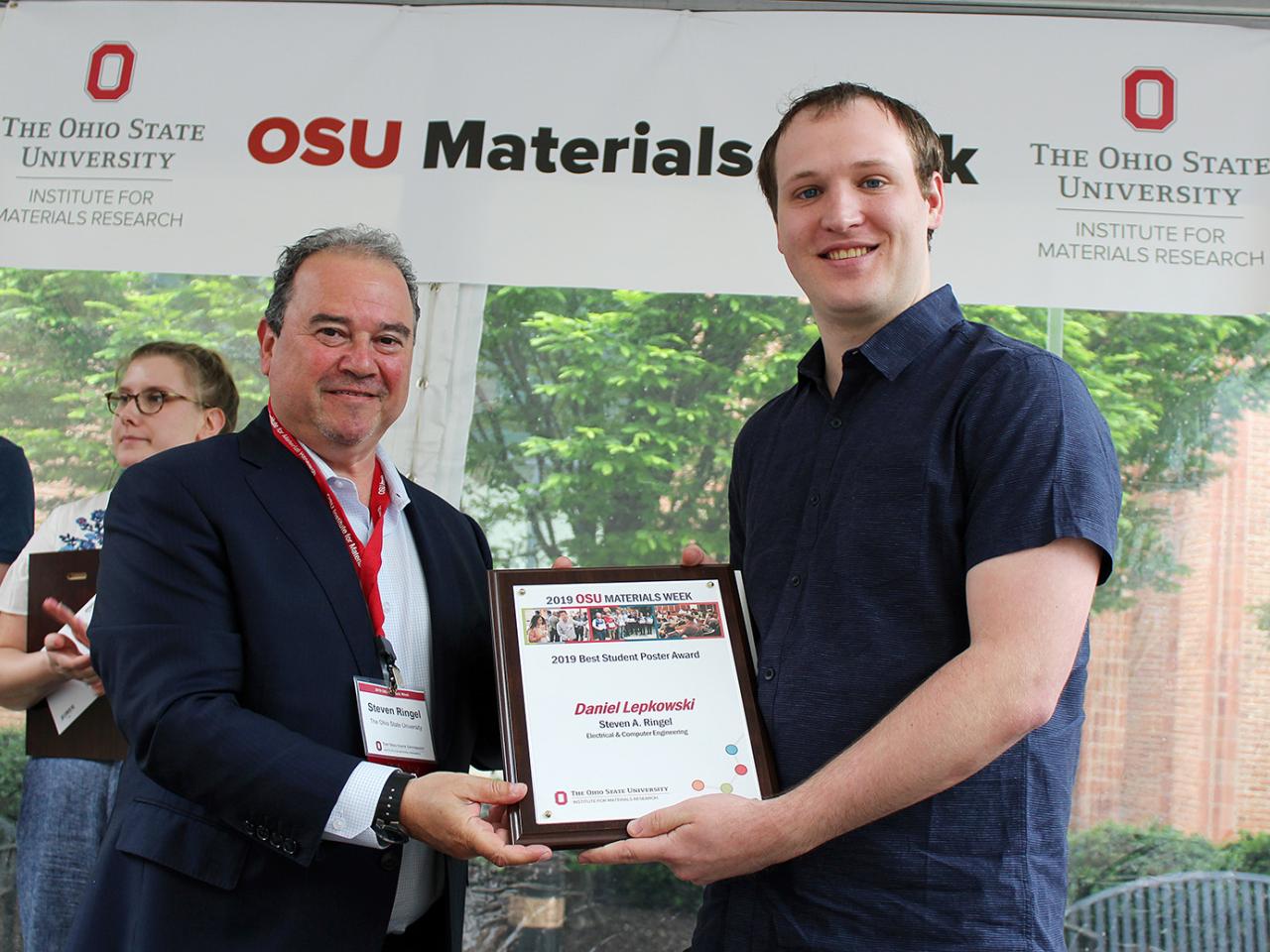 Man being presented with award