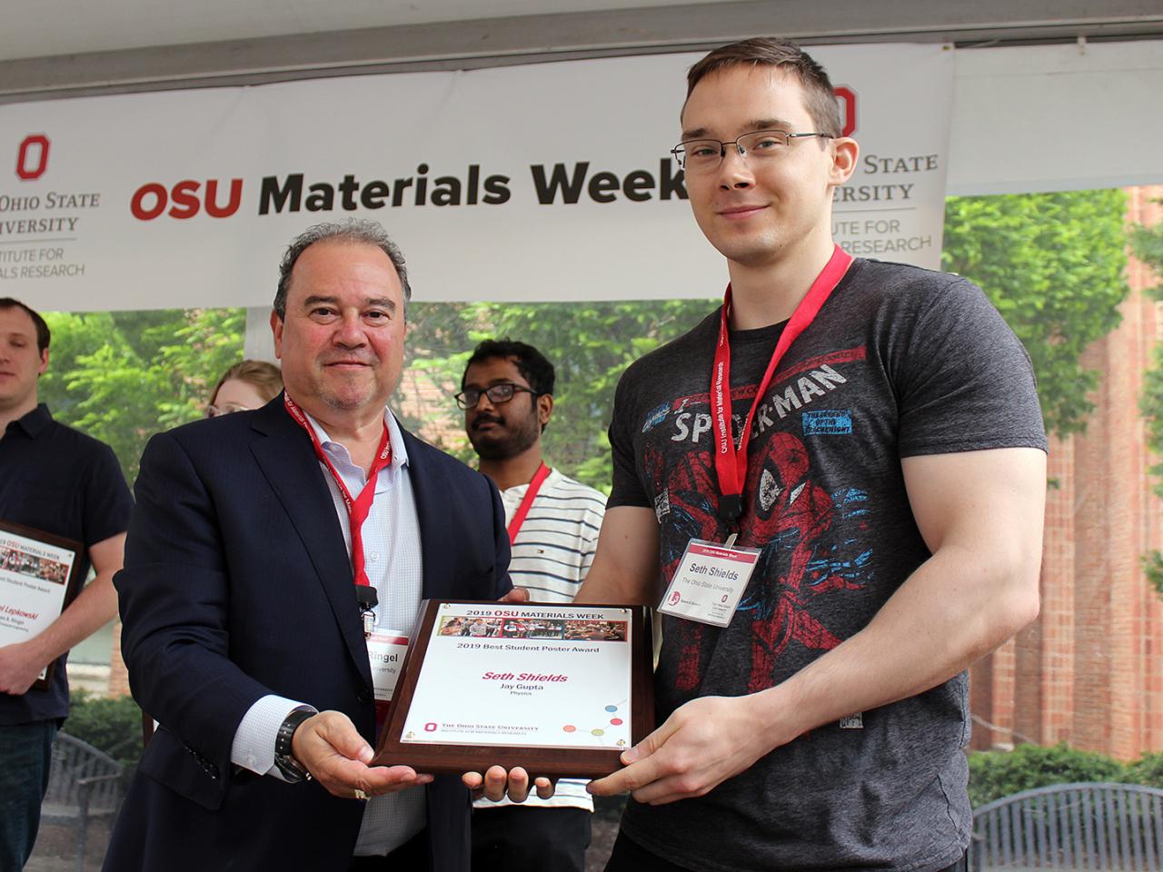 Man being presented with award