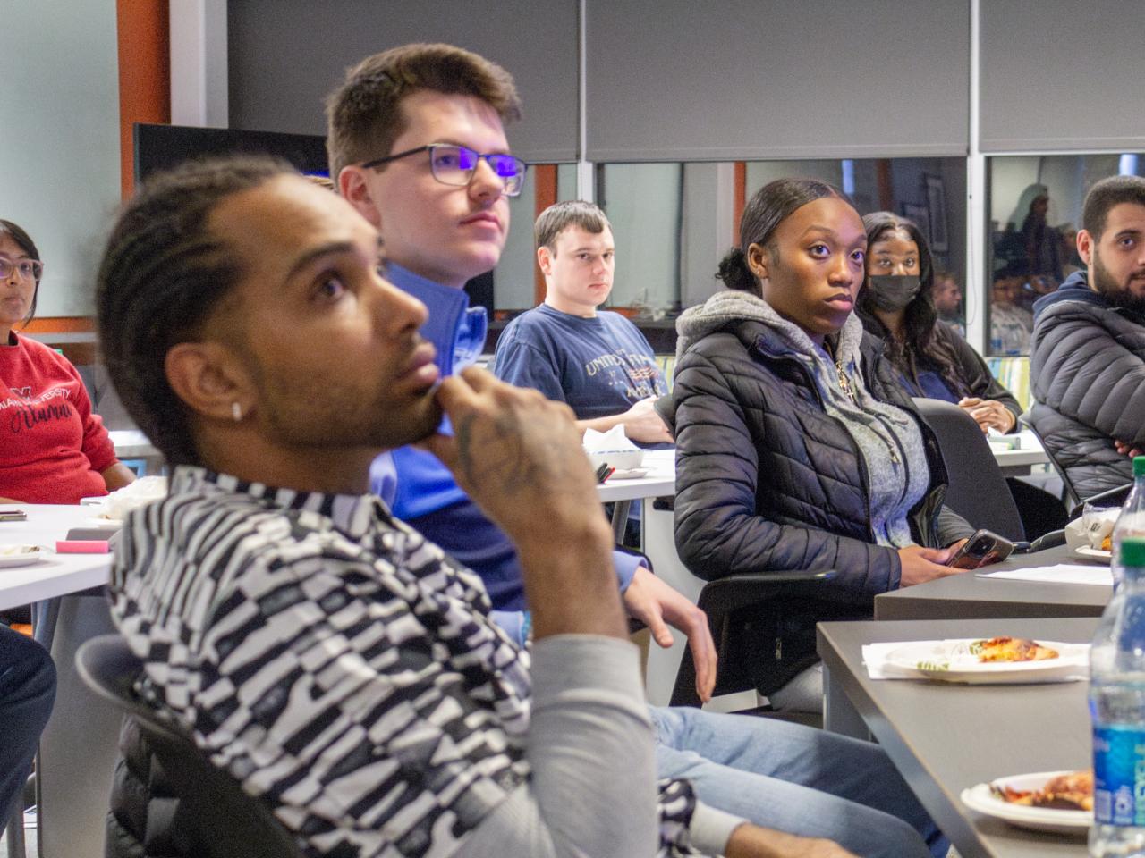 Students listening to a presentation about learning opportunities at the IMR Innovation Lab.