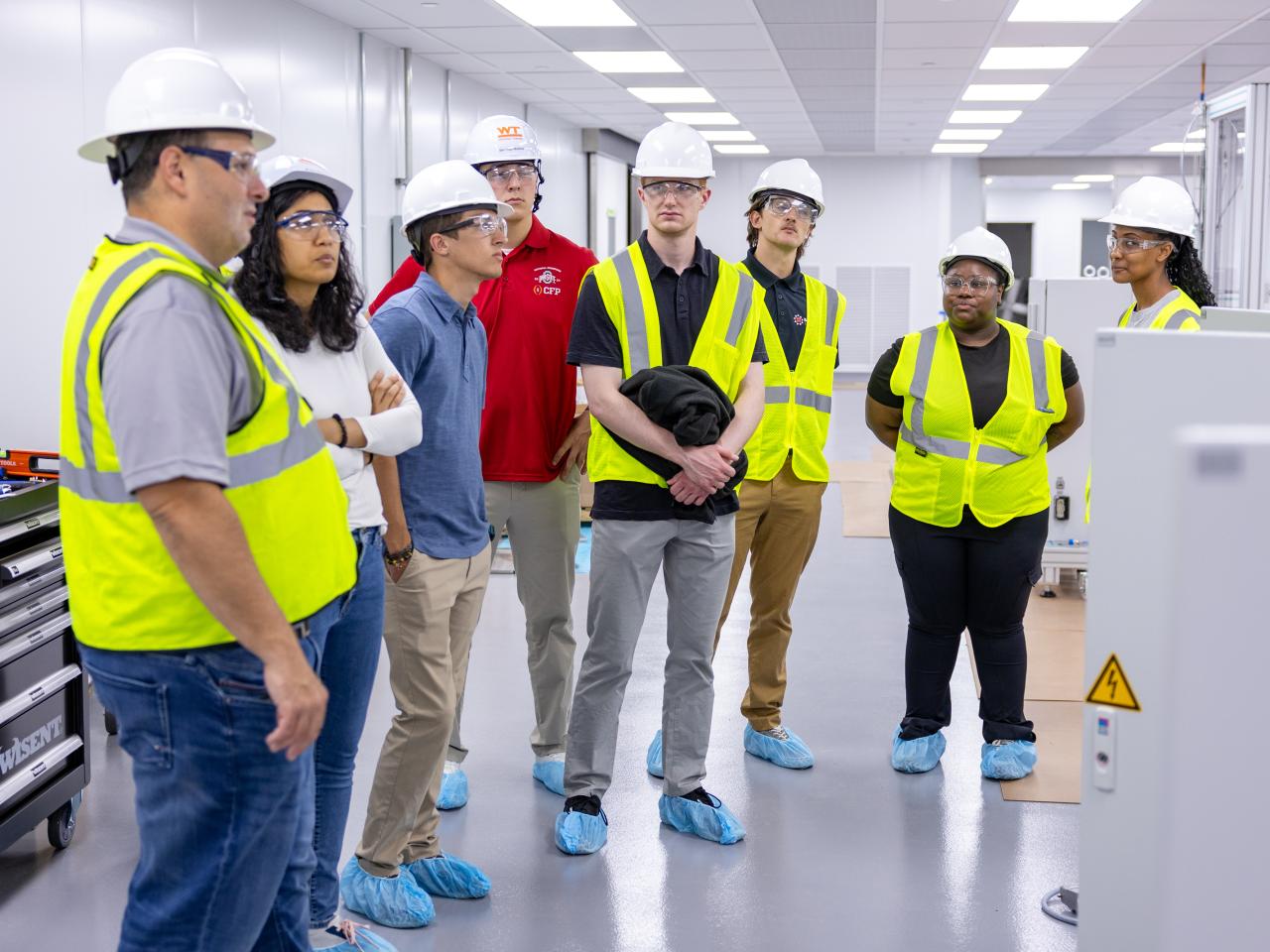 BATTERI interns learn about the set-up process of the machine at the Battery Center.