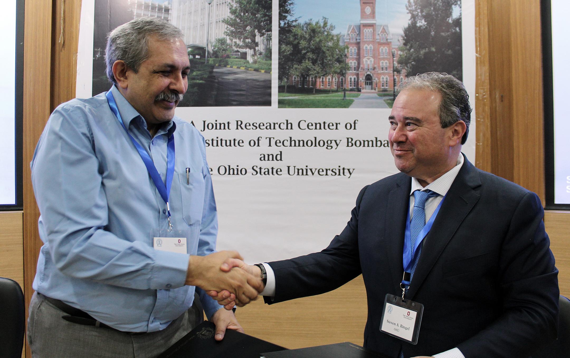 Devang Khakhar and Steven Ringel shaking hands