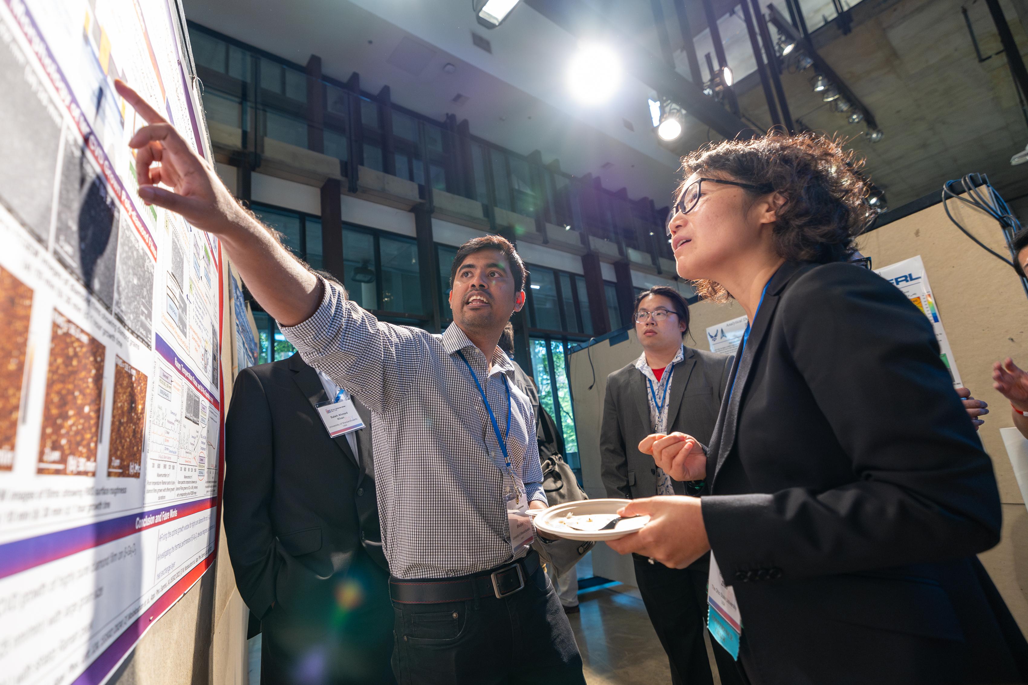 Prof. Hongping Zhao (right) at the GOX 2024 poster session.