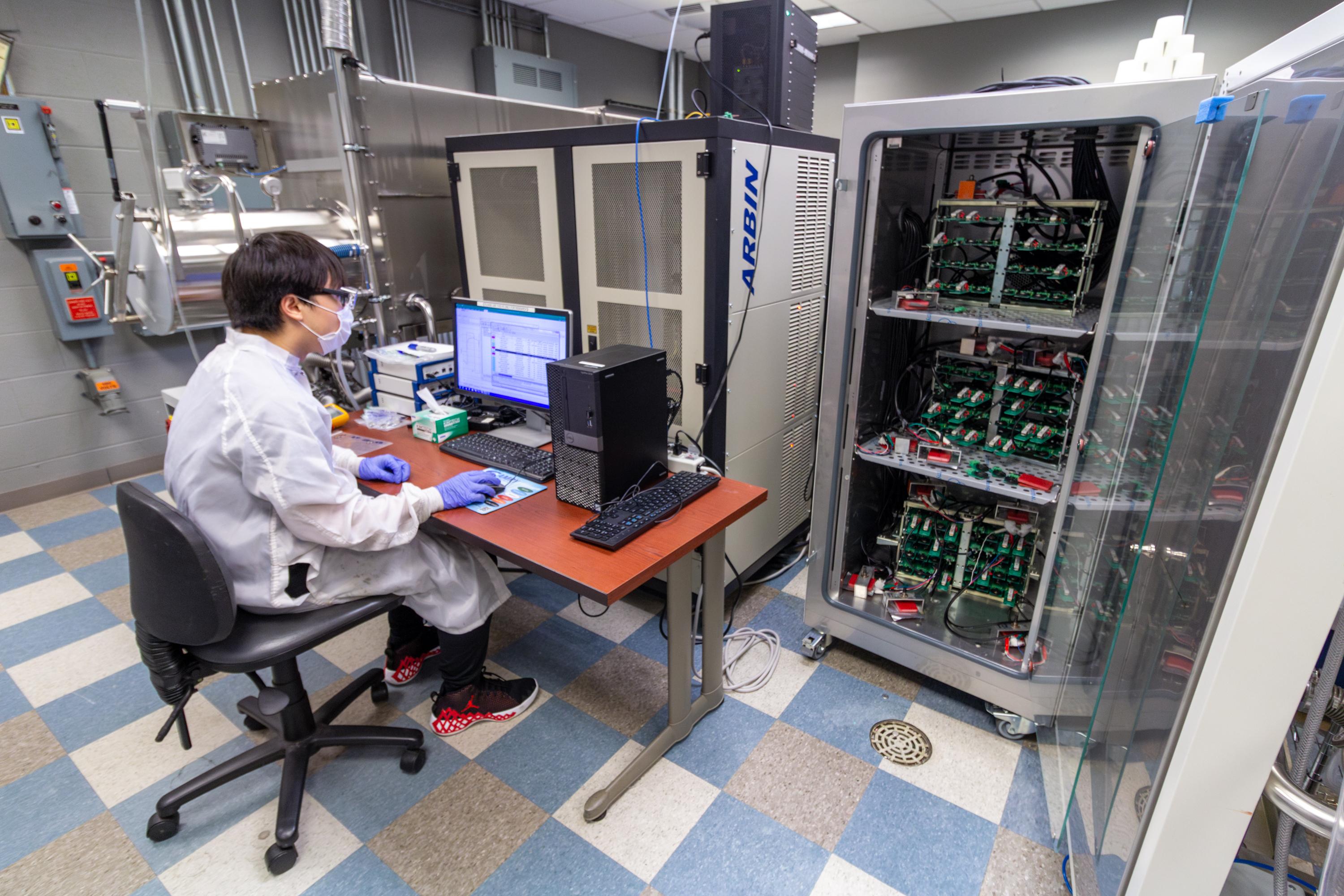 Student testing battery cells at the Energy Innovation Lab.