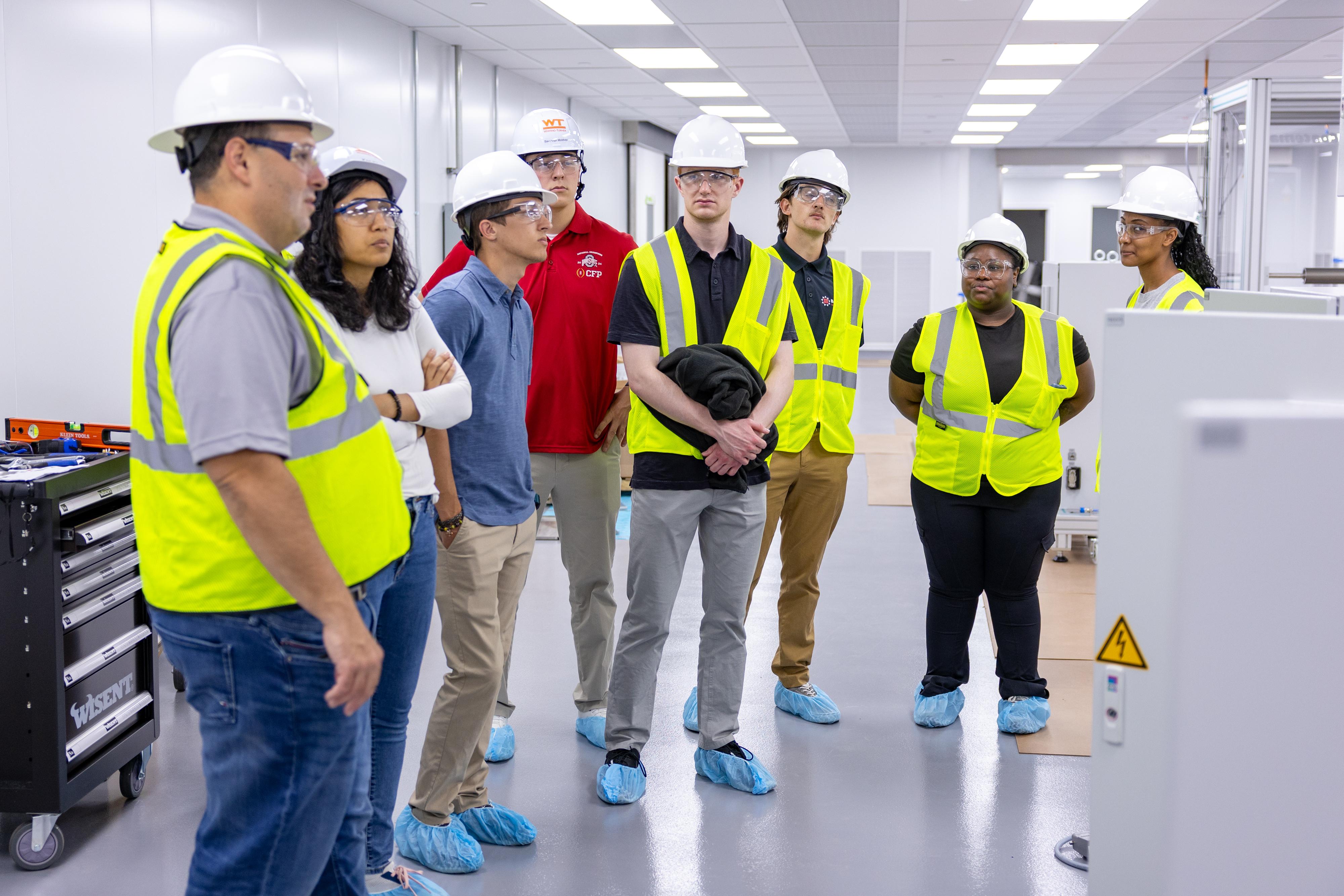 BATTERI interns learn about the set-up process of the machine at the Battery Center.