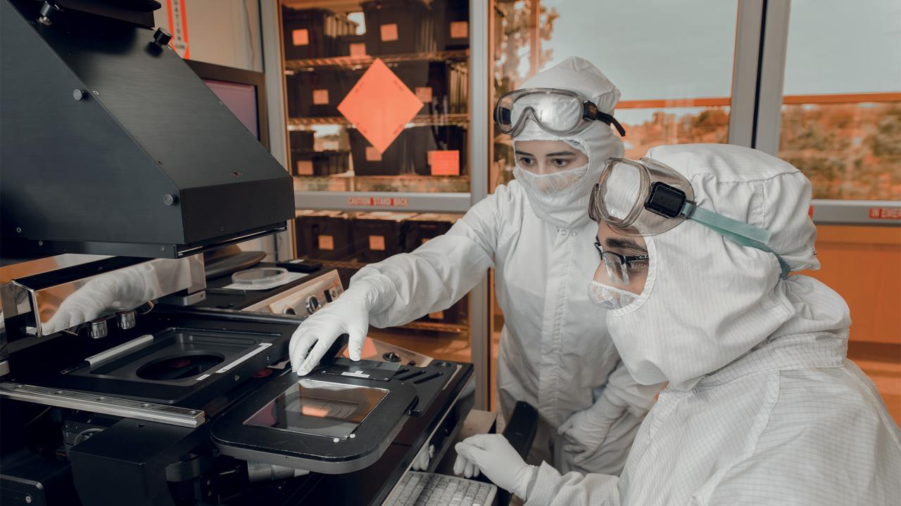 Two researchers examining technology