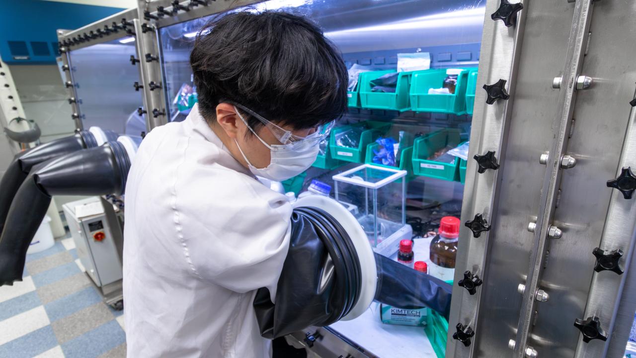 Student working in at a glovebox in the Energy Innovation Lab at Ohio State.