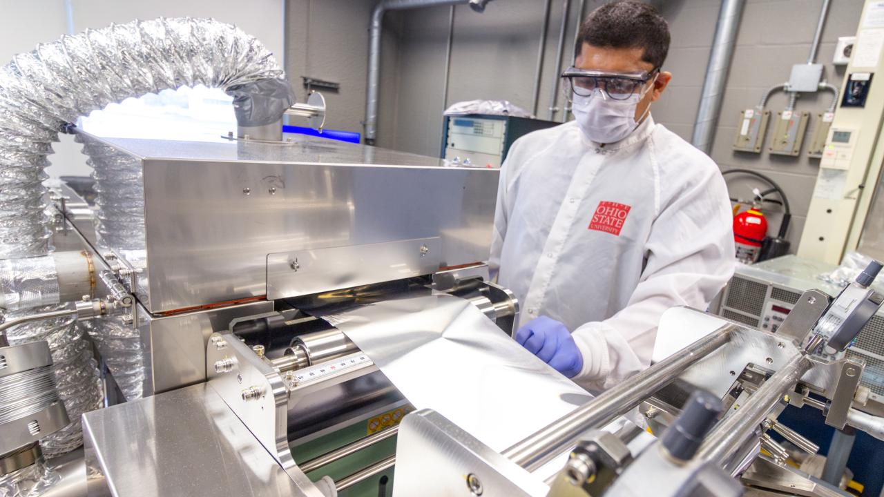 Student working at a coating system in the Energy Innovation Lab.