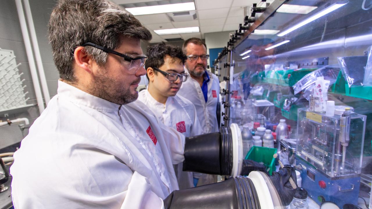 Researchers training at a glovebox in the Energy Innovation Lab.