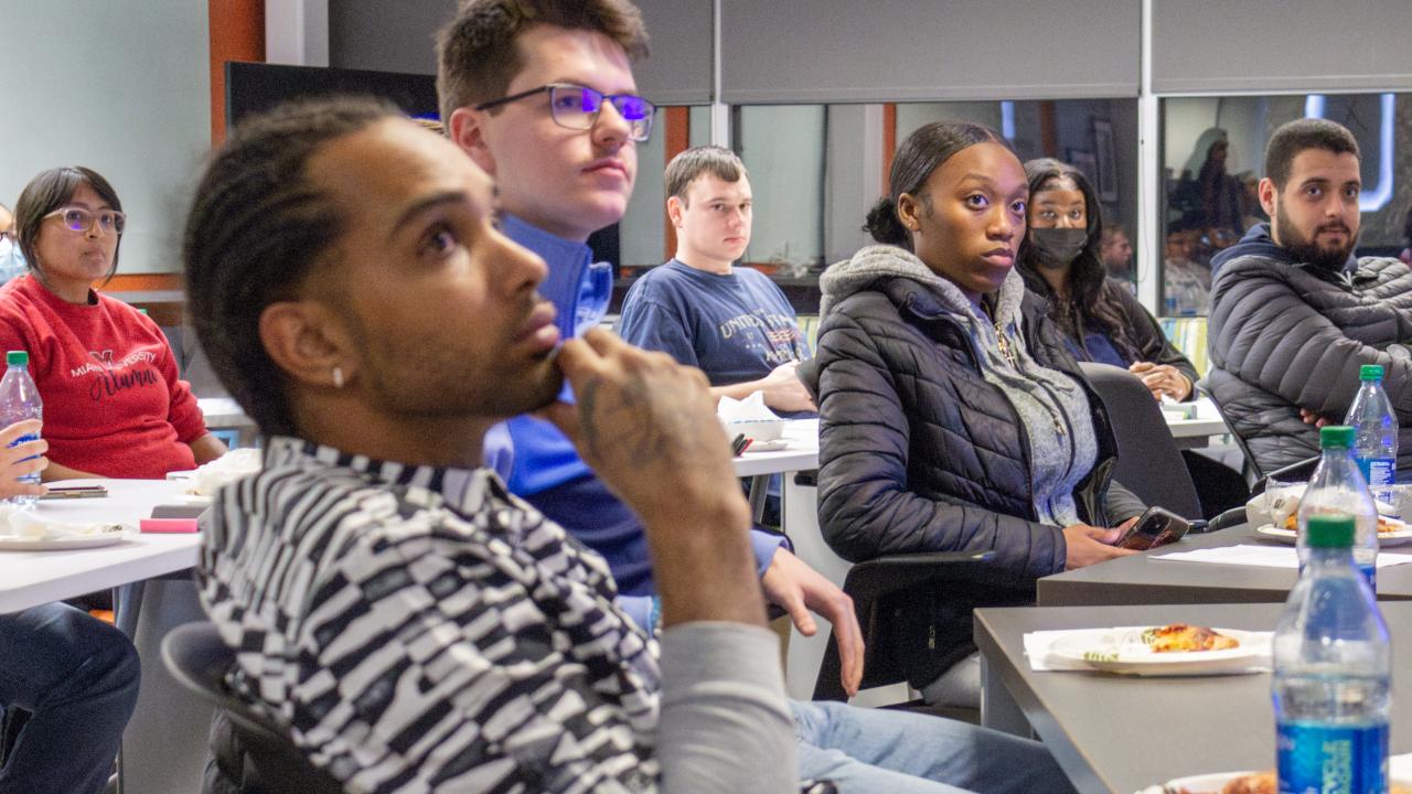 Students listening to a presentation about learning opportunities at the IMR Innovation Lab.